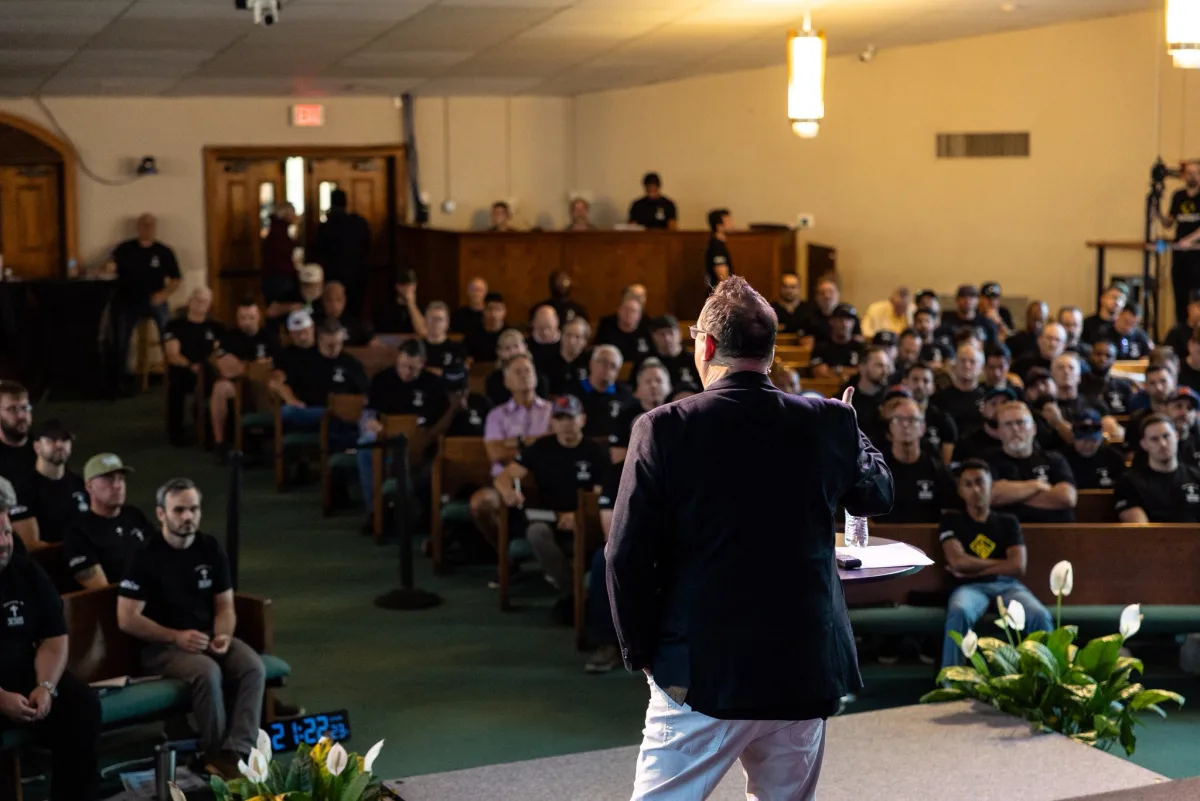 Michael speaking to a packed room